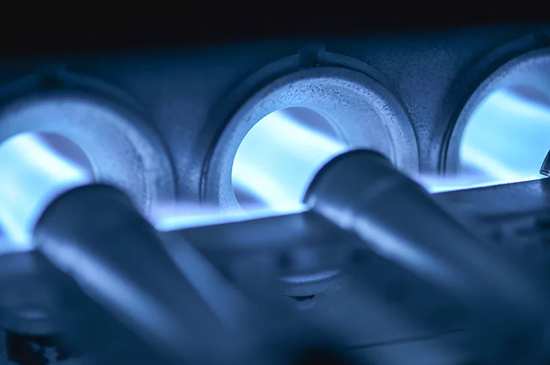 Gas furnace burners glowing blue